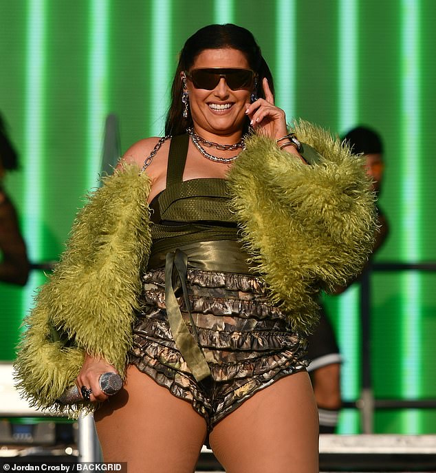 She paired the hotpants with a vibrant winged cape and chunky silver necklace and earrings