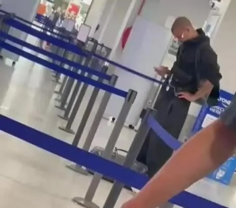 Romeo Beckham in line at an airport.