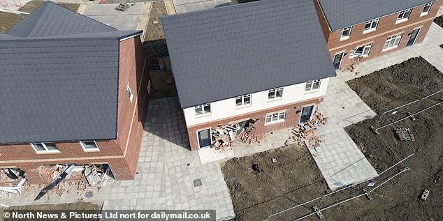A row of newbuild houses were left in ruins after a 'teenager' was seen driving into them with a JCB