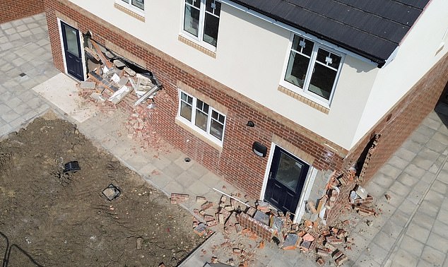 Pictured: One of the homes that the teenager rammed into while driving a JCB
