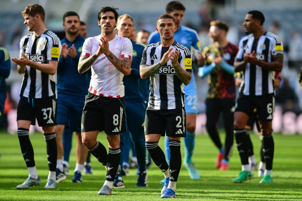 Soccer players clapping for fans.