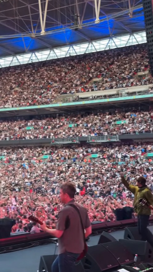 Thousands of Oasis fans at a sold-out Wembley Stadium concert.