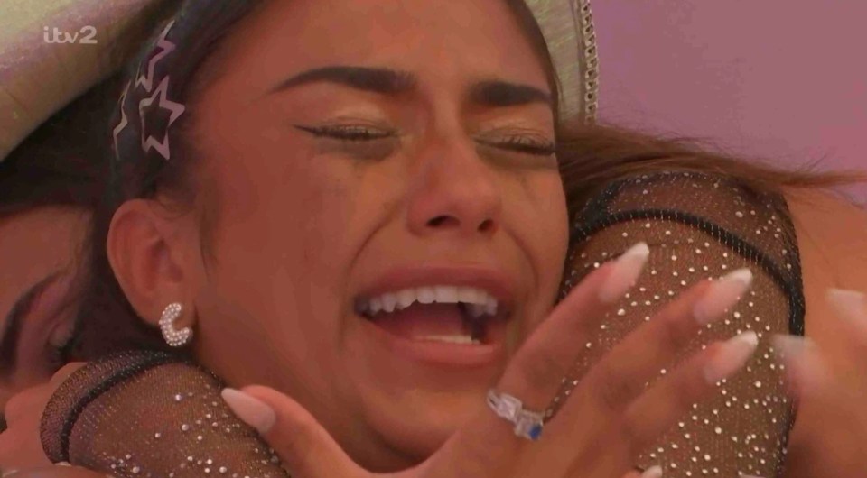 Upset woman crying while being comforted.