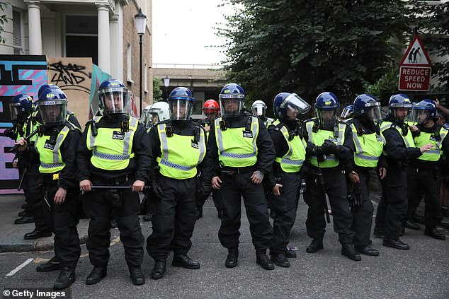 Police officers stand in riot gear at Notting Hill Carnival 'Family Day' in August 2024