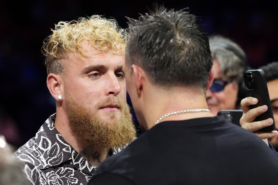 Oleksandr Usyk and Jake Paul after a boxing match.
