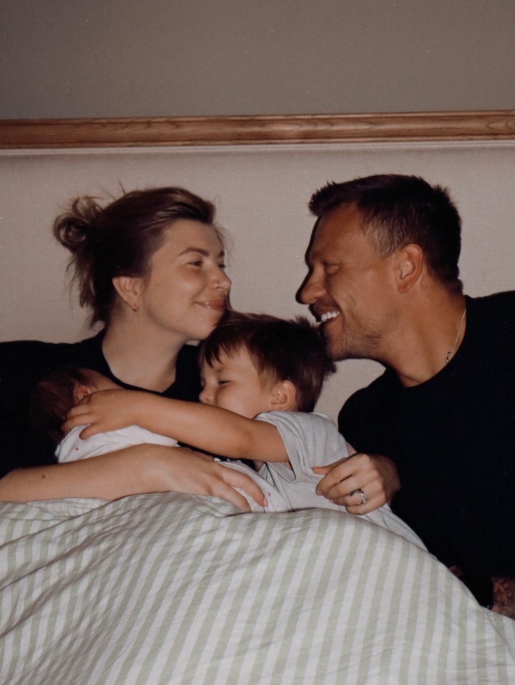 Family photo of Olivia and Alex Bowen with their newborn daughter and son.