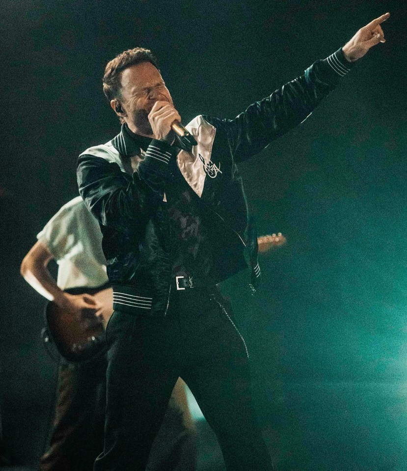 Olly Murs performing on stage.