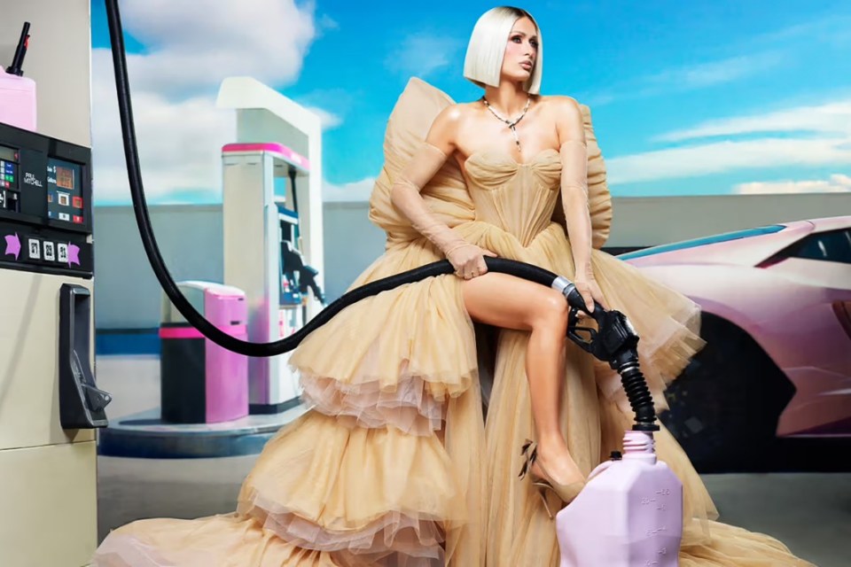Paris Hilton poses in a garage forecourt for a new haircare shoot