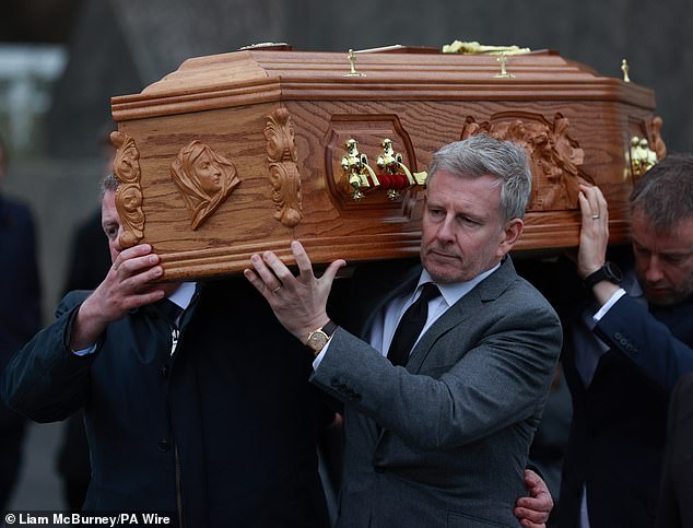 Patrick looked bereft as he carried Mary's coffin through his home village, where he was joined by close family and friends at the Church of the Sacred Heart