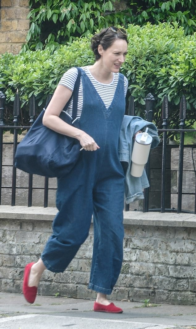 Phoebe Waller-Bridge, 40, was spotted in north London carrying a large tote bag while she showed off her blossoming bump in a pair of denim dungarees and striped T-shirt