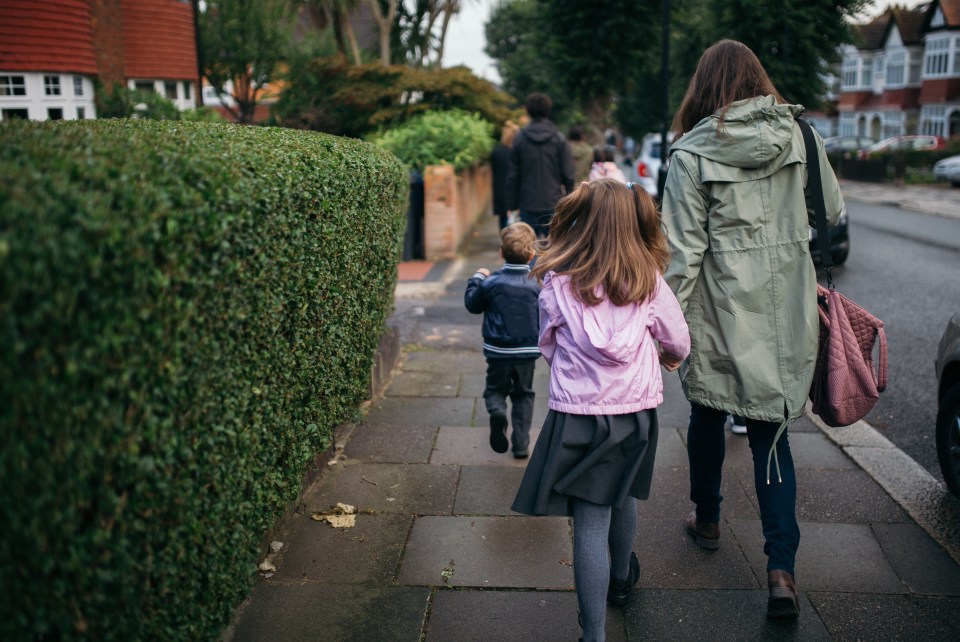 Family walking children to school.