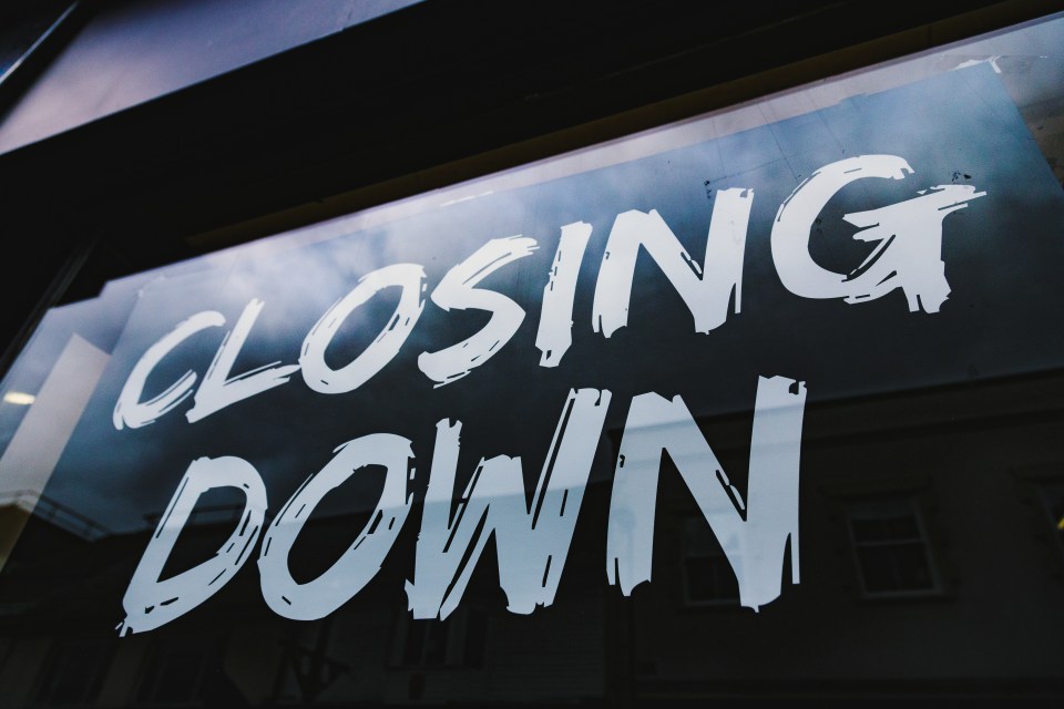 Store window with a "Closing Down" sign.