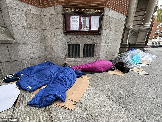 Dozens of migrants are pictured sleeping rough outside Westminster Cathedral in April of this year