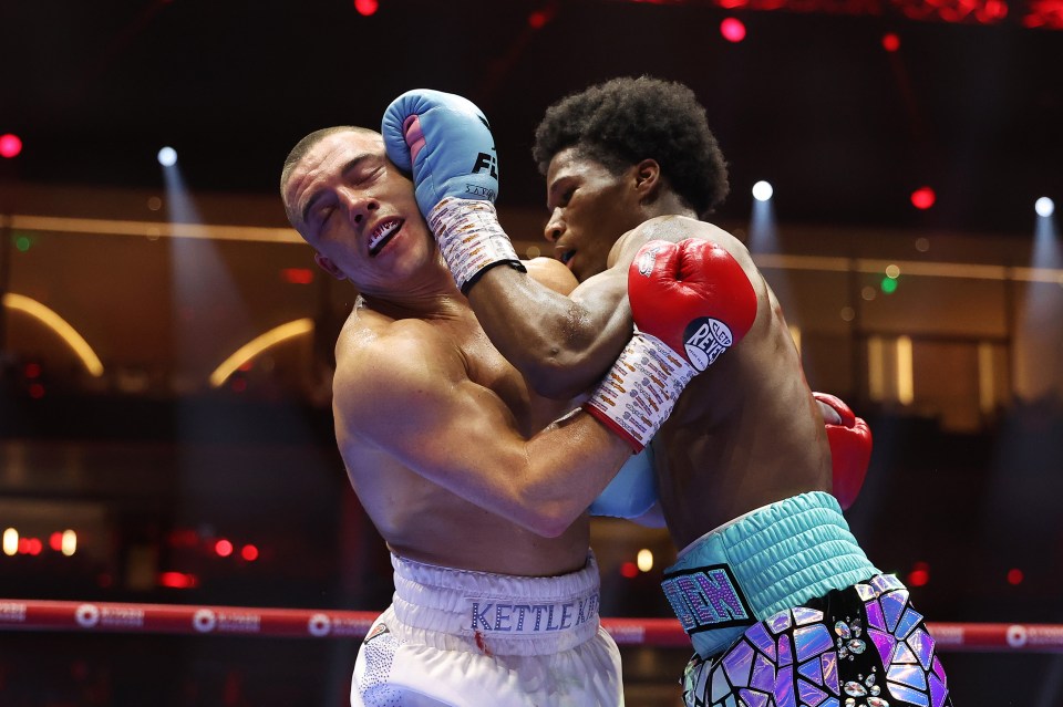 Two boxers exchanging punches in a boxing match.