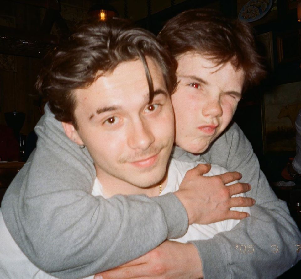 Two young men hugging.