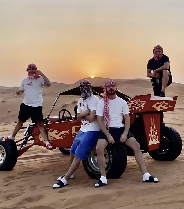 Hellbanianz leader Ervin Selita posing in Dubai with three other members, with their faces covered with keffiyehs