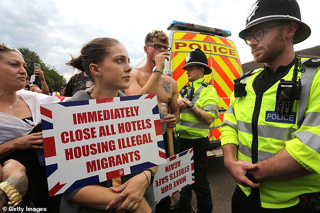 Protesters and policeman come face to face in Norwich in Sunday as people take to the streets to protest against the Brook Hotel's housing of asylum seekers