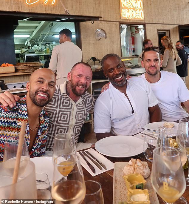 Rochelle Humes has raised eyebrows after sharing a photo of Myleene Klass' ex-husband Graham Quinn (centre left) posing with her husband Marvin (left) in Ibiza on Monday
