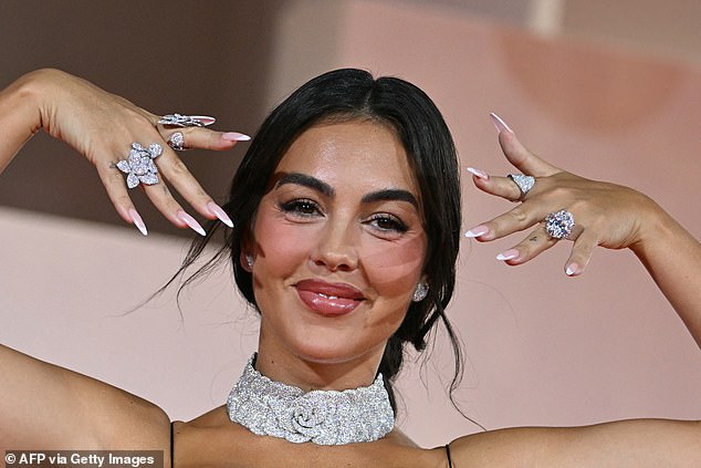 Cristiano Ronaldo 's fiancée Georgina Rodriguez flashed her giant sparkling engagement ring on Sunday as she hit the red carpet at the Filming Italy Venice Award