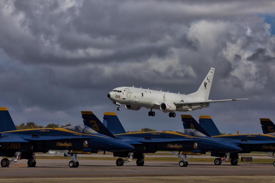 Boeing P-8 Poseidon flying over Blue Angels jets.