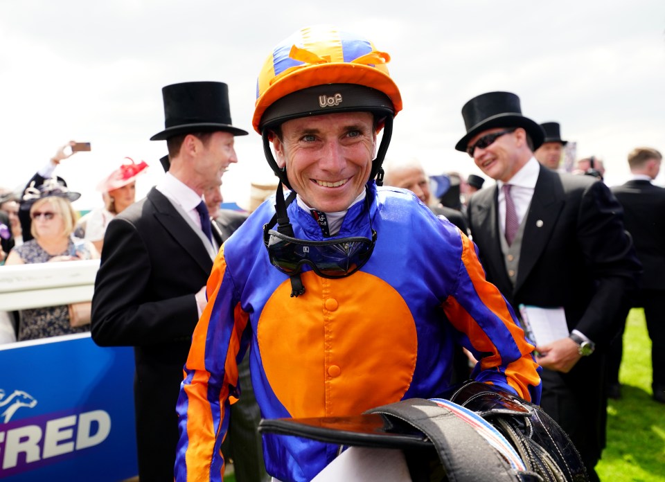 Jockey Ryan Moore celebrating a win at Epsom Downs Racecourse.