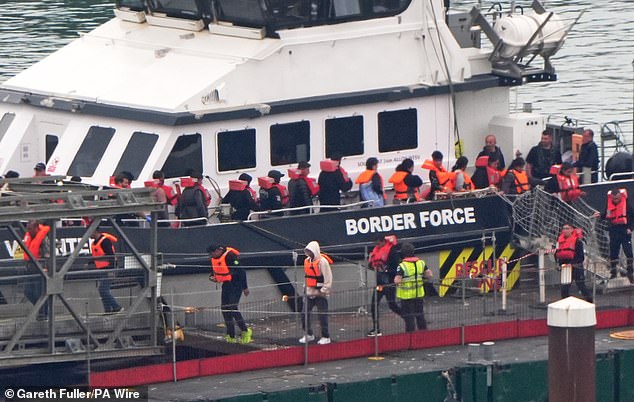 Migrants are brought to the Border Force compound at Dover, Kent on August 13