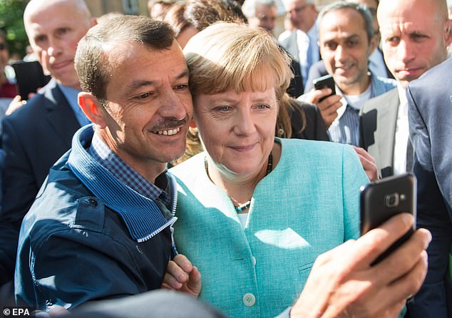 Angela Merkel takes a selfie with a refugee outside a Berlin refugee reception centre in 2015