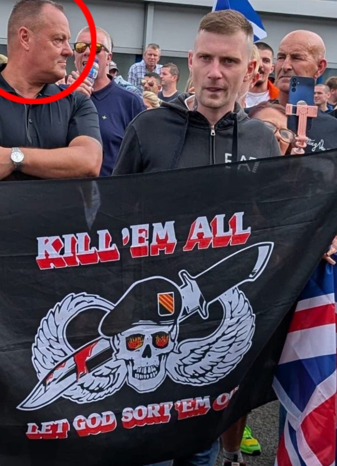 Protestors holding a flag that says "Kill 'em all" and "Let God sort 'em out".