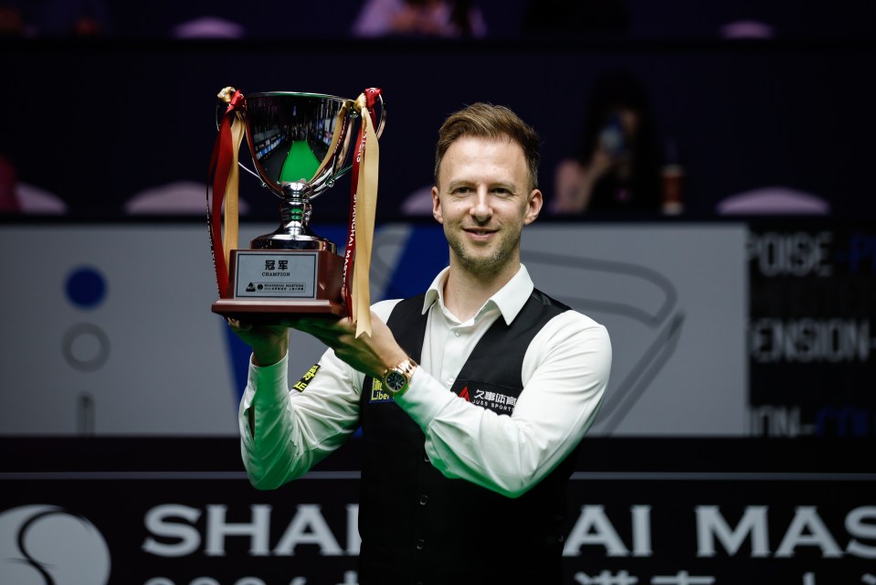 Judd Trump of England holding the Shanghai Masters trophy.