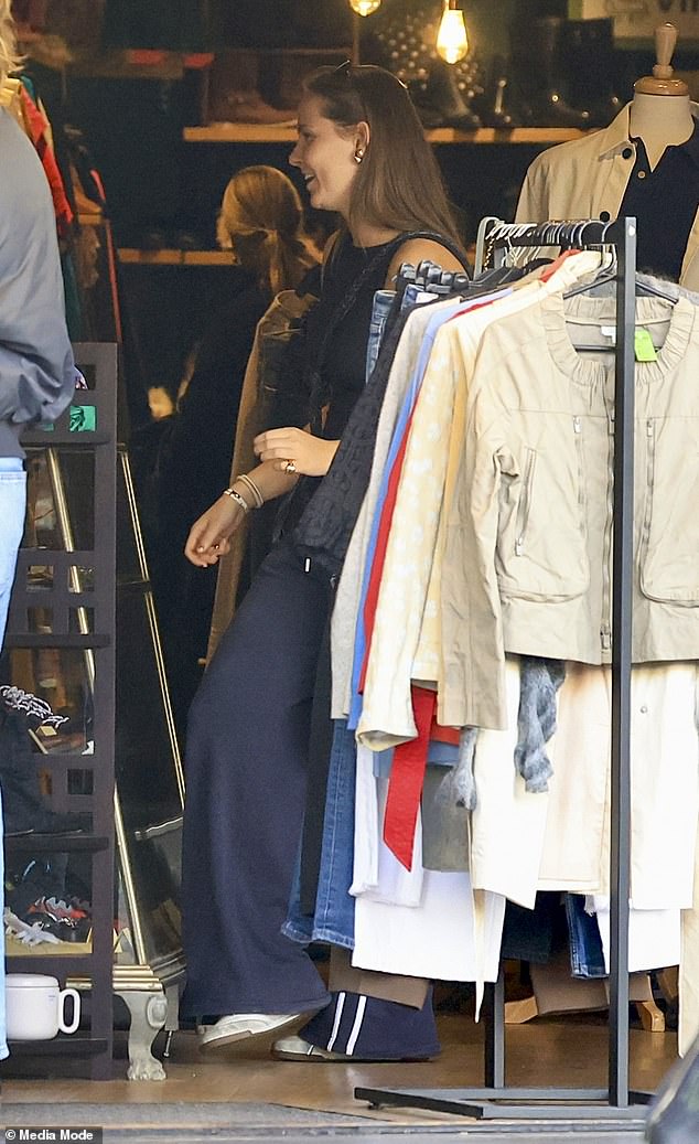 She completed her casual ensemble with a satchel handbag, blue jumper, white sneakers and a pair of sunglasses worn on her head