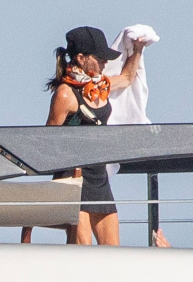 The former footballer and Spice Girl enjoyed a spot of reading while topping up their tans after he was caught cheekily pinching her bottom