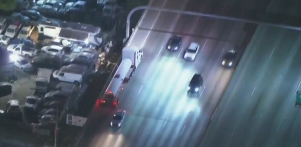 Aerial view of police pursuit on I-10 W in downtown Los Angeles.