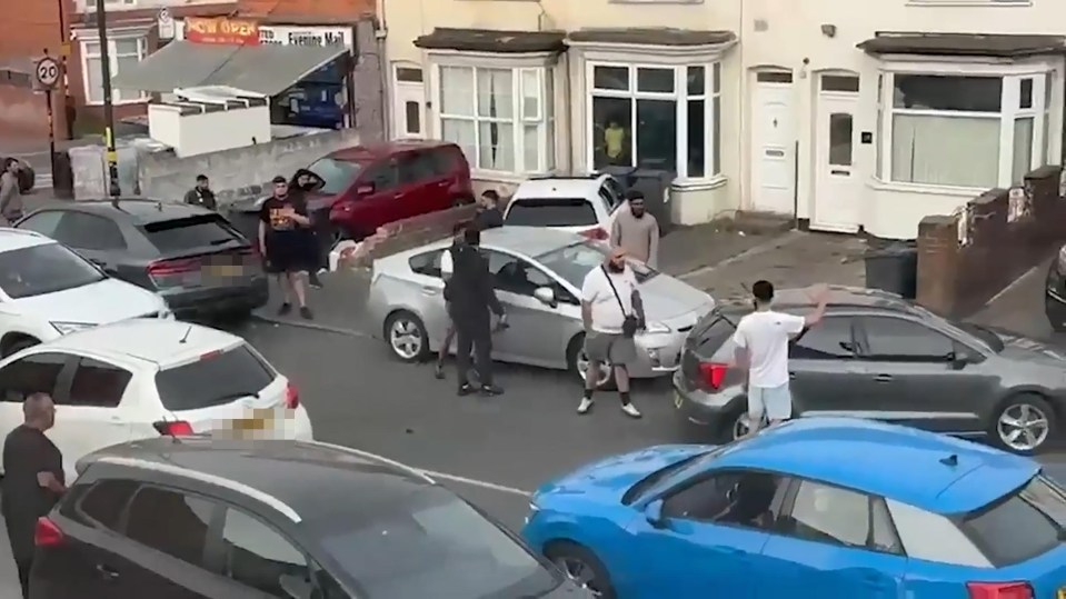 People arguing in a residential street.