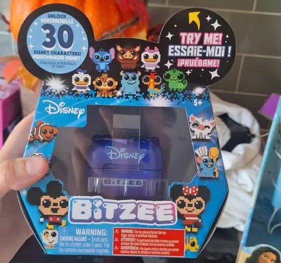A person holds a Disney Bitzee toy box.