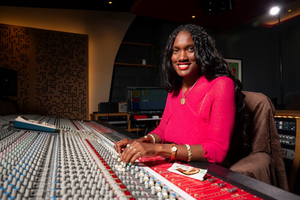 Dr. Natalie Hyacinth composing music in a recording studio.