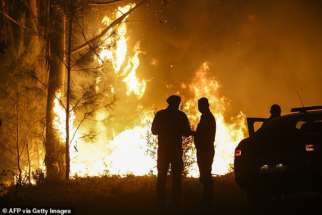 The xtreme weather is wreaking havoc across Europe, pushing emergency services to their limits as wildfires heatwaves and storms sweep across the continent. Pictured: Firefighters work on a wildfire in Arouca, northern Portugal on July 30, 2025