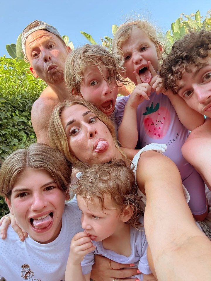 Family selfie with kids making silly faces.