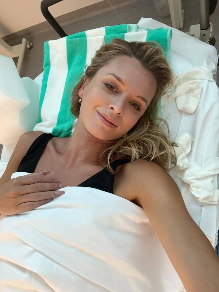 Woman lying in a hospital bed.