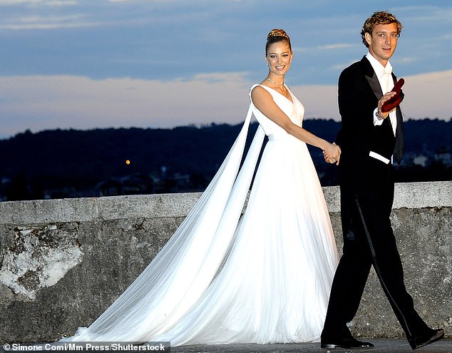 For her wedding ceremony in 2015, Beatrice Borromeo wore a bespoke ivory lace gown by Giorgio Armani Prive, featuring a scalloped-boat neck, three-quarter length sleeves and column silhouette