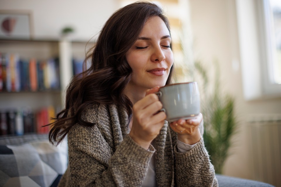 Woman enjoying a hot drink.