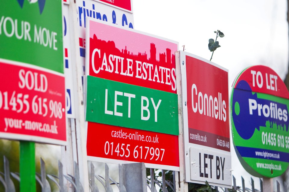 a row of real estate signs including one for castle estates
