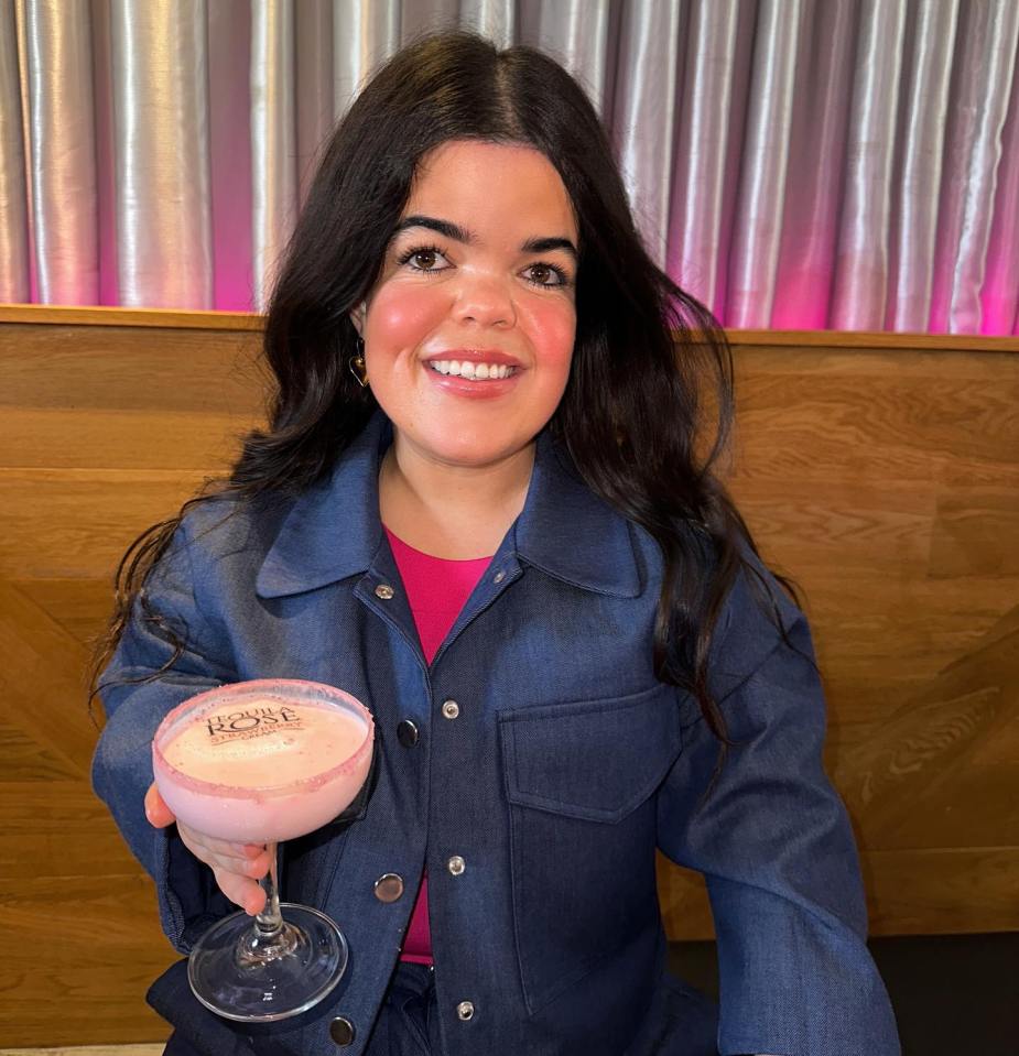 Meryl Williams, winner of The Traitor, holding a cocktail.