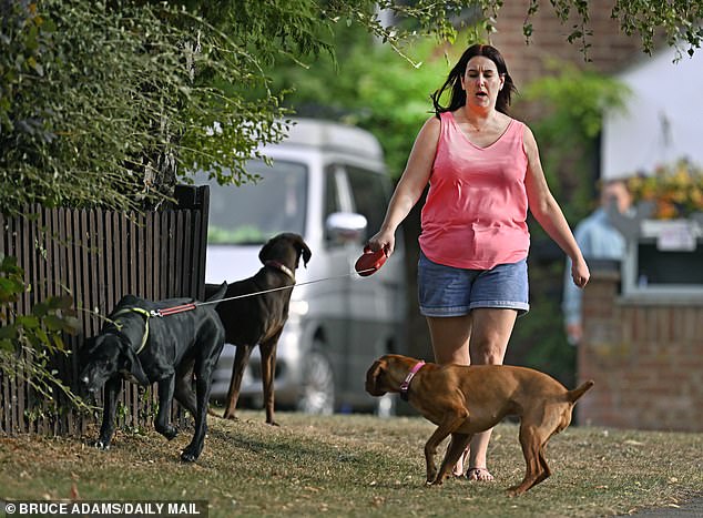 She was pictured leaving HMP Peterborough in a taxi on Thursday before being spotted walking her dogs, pictured