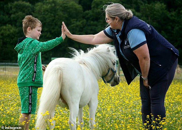 Cherene believes Bubbles, a British miniature horse, helped a non-verbal child, Conor, learn to speak. Pictured: Cherene and Conor