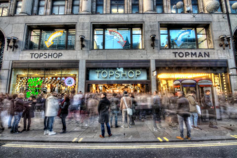 Topshop and Topman stores on Oxford Street, London, with a crowd of people outside.