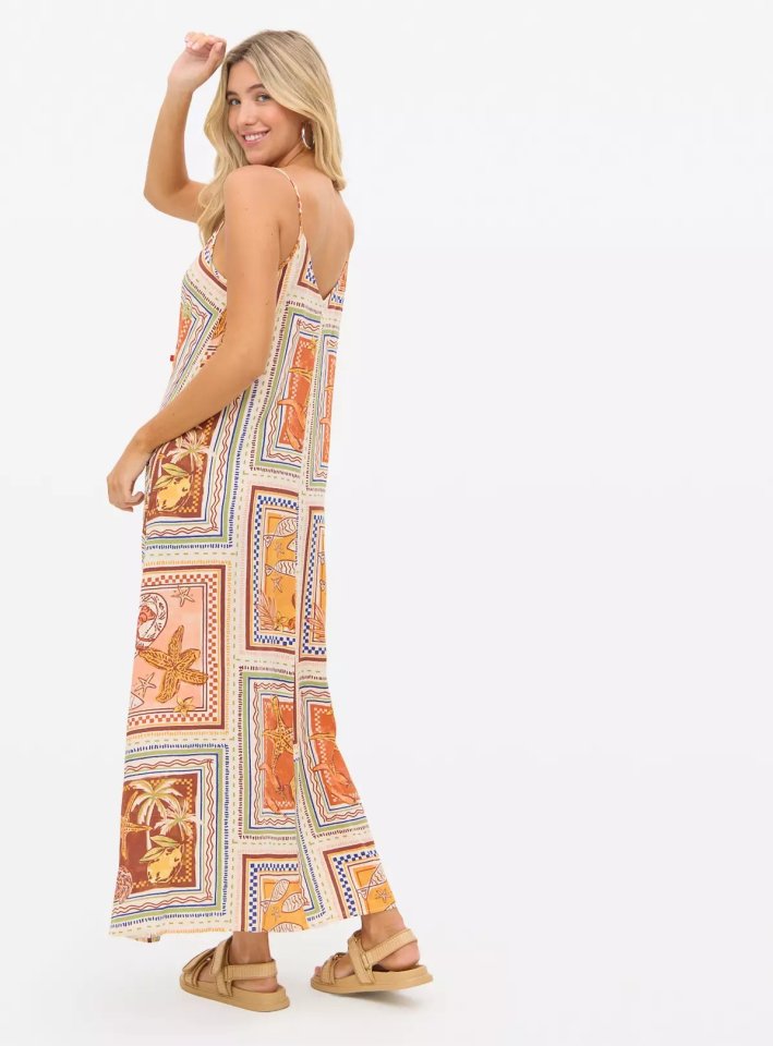 Woman wearing a patterned maxi dress.