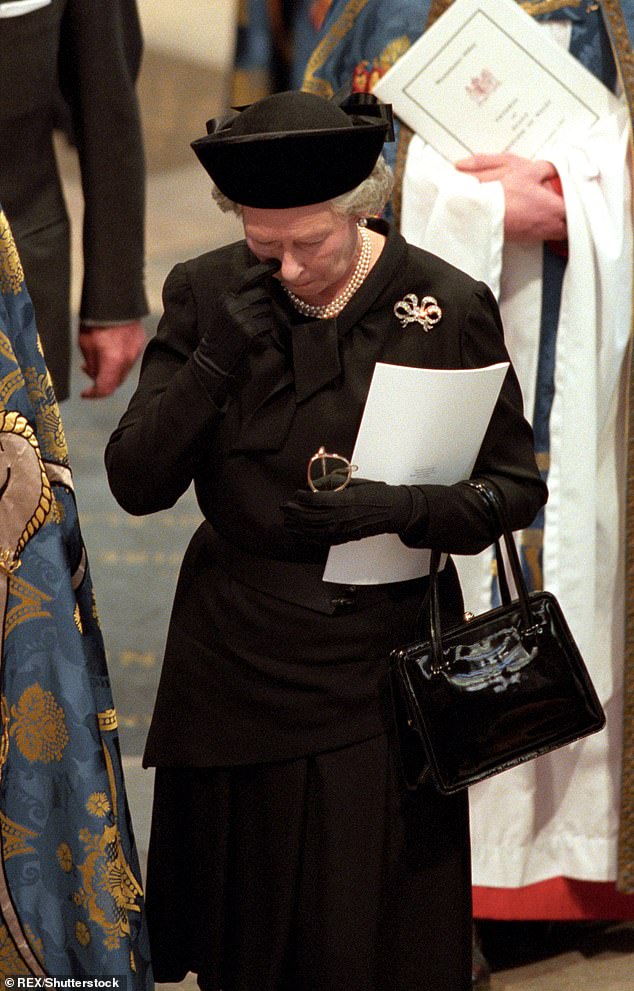 The Queen is pictured in Westminster Abbey during Diana's funeral