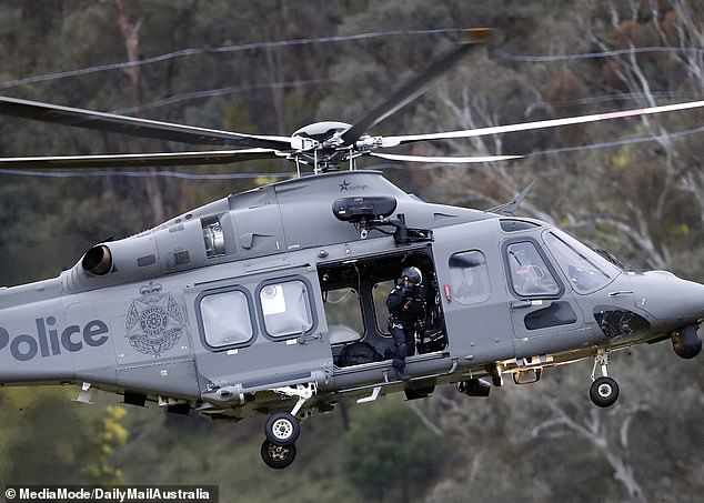 Heavily armed police, special operations units and air support scour the mountains
