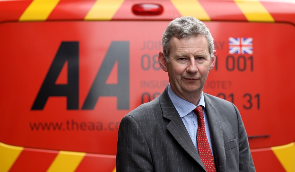 Edmund King, AA president, in front of an AA patrol vehicle.