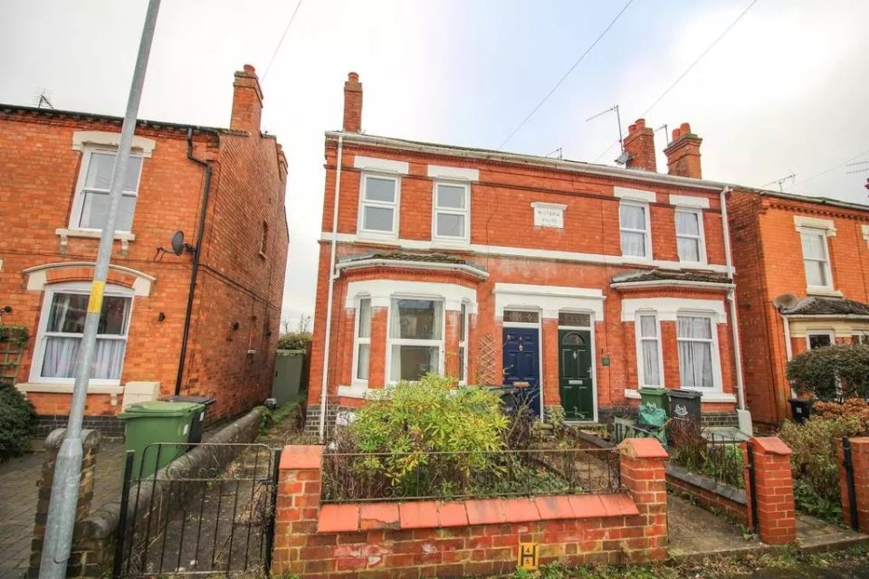 Exterior view of a brick house for sale.